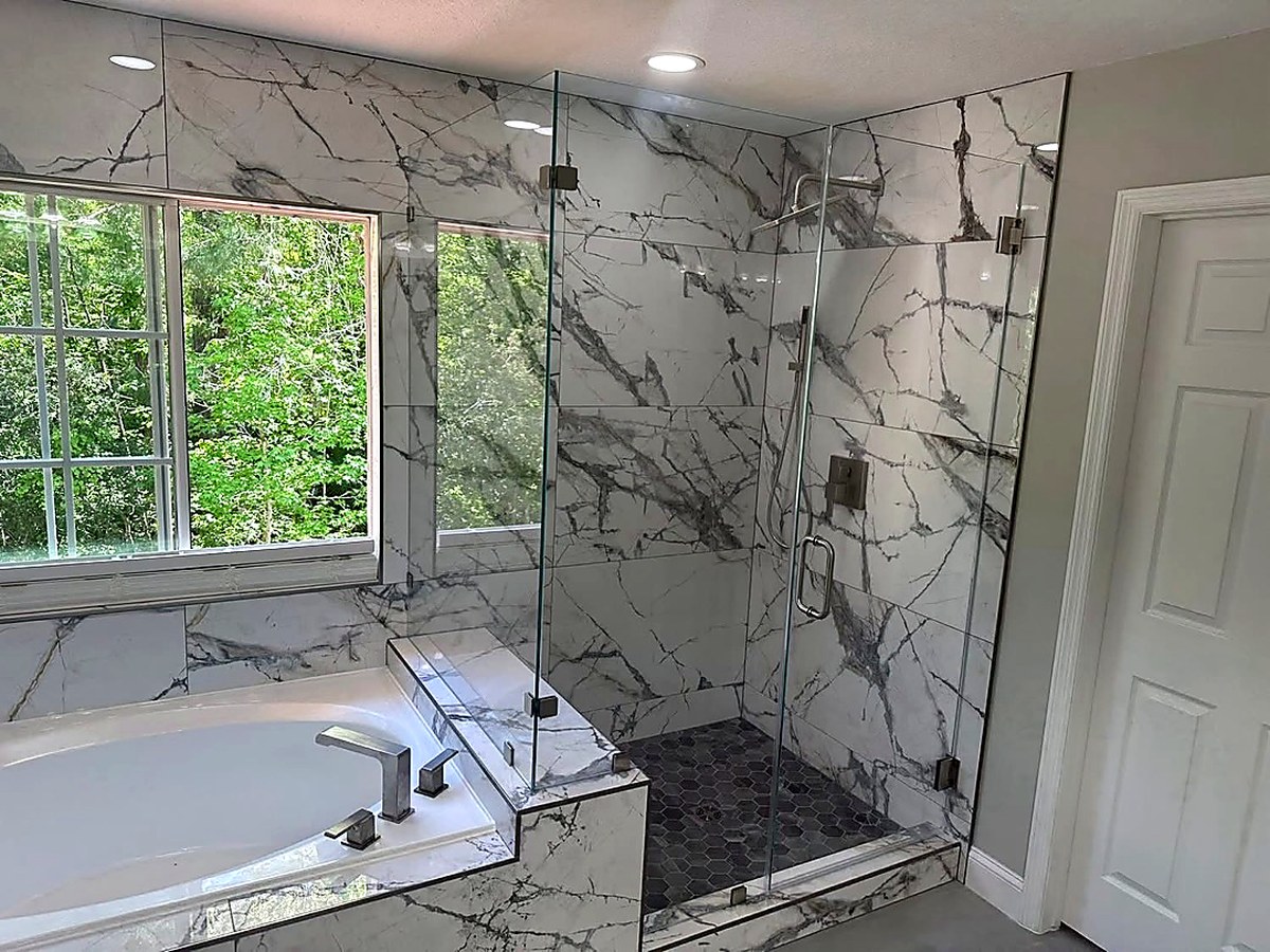 Large-format marble shower with glass enclosure, Central Florida