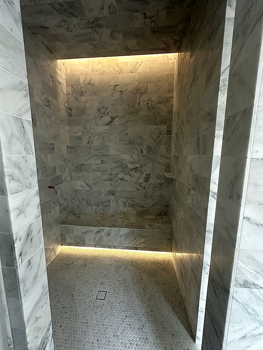 Marble shower with LED niche lighting by KV Tileworks, Central Florida