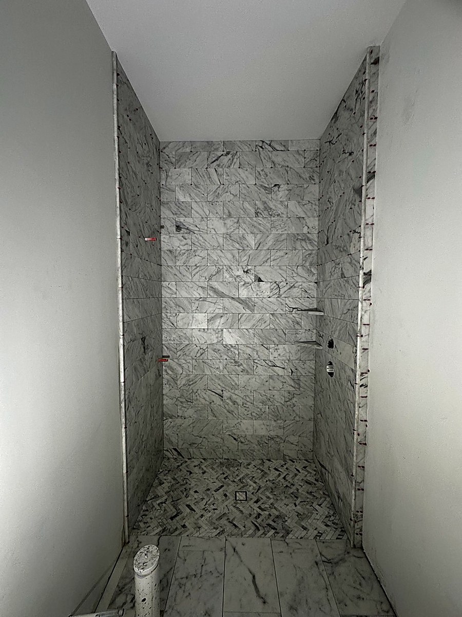 Marble shower in progress by KV Tileworks, Central Florida