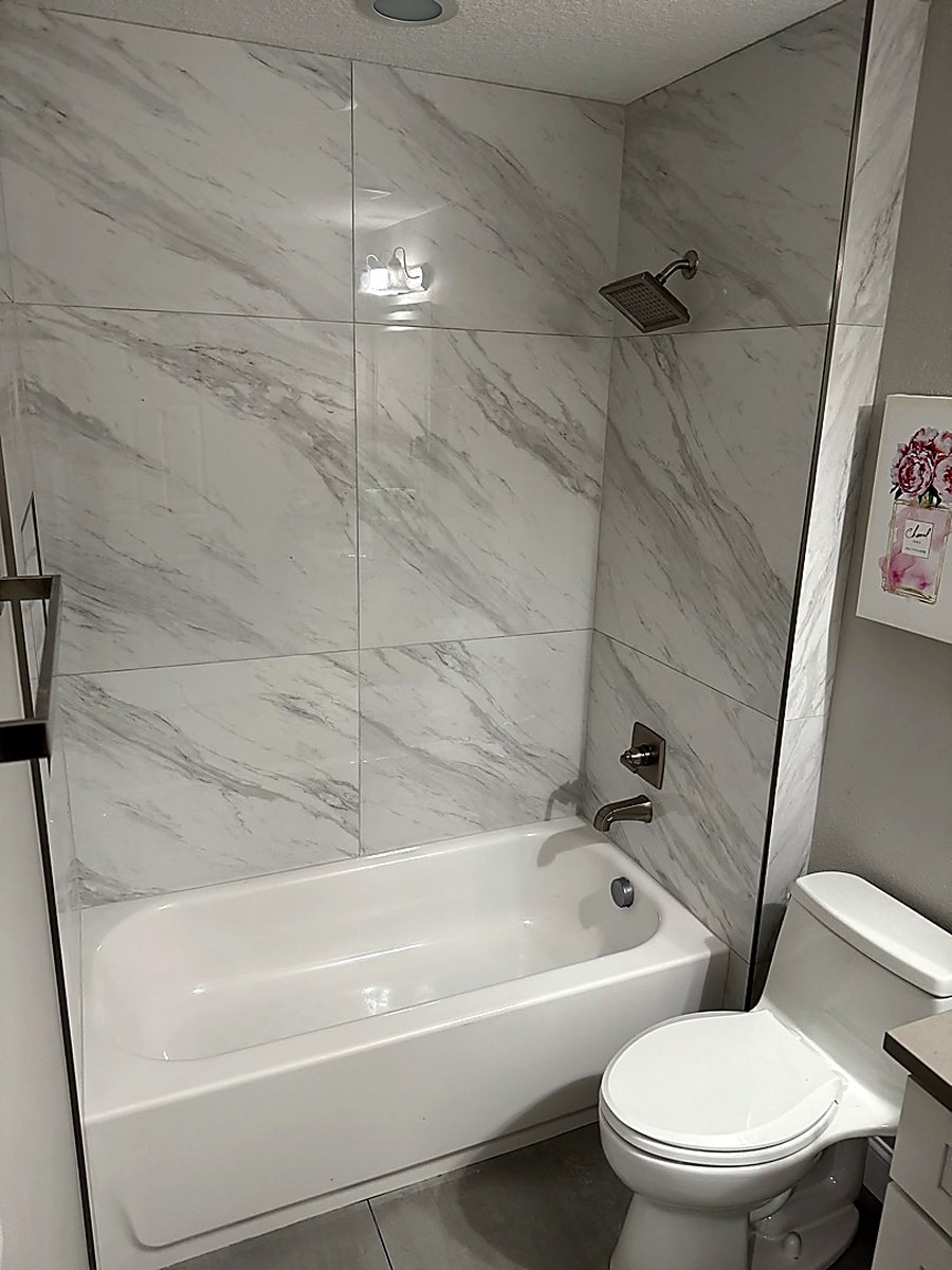 Large format marble tub surround by KV Tileworks, Central Florida