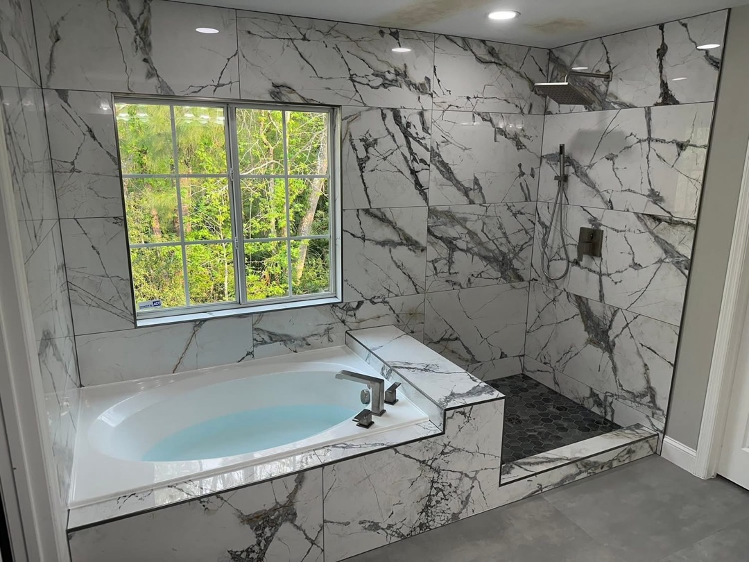Finished Calacatta marble tile shower and tub surround - KV Tileworks Central Florida